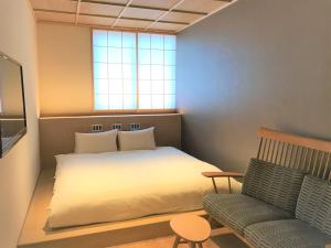 Postel nebo postele na pokoji v ubytování 利々 京都 lili hotel kyoto