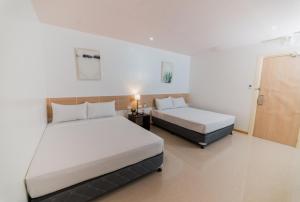 Voodi või voodid majutusasutuse Soi Suites toas