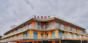 a large orange building with a large sign on it at Hotel Largo Beach in Sunny Beach