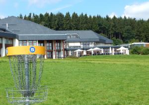a frisbee golf goal in front of a building at Landhaus Nordhelle Garni in Meinerzhagen