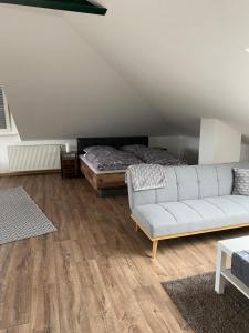 a living room with a couch and a bed at Appartement 7 in Hilter in Hilter am Teutoburger Wald