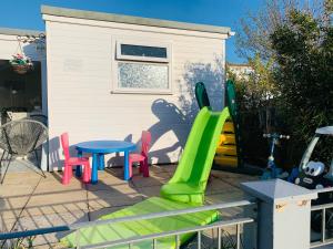 a playground with a slide and a table and chairs at Nicolas Devon air bed and breakfast in Ilfracombe +20 photos