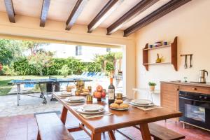 a dining room with a table with food on it at Villa Siena by Villa Plus in Cala en Blanes