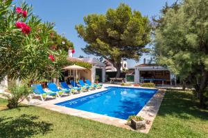 a swimming pool with lounge chairs and a house at Villa Siena by Villa Plus in Cala en Blanes