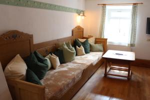 a couch with pillows on it in a room at Grafn-Hof in Schleching