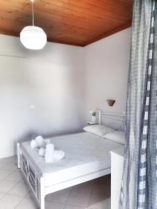 a room with two beds and a wooden ceiling at Orange Apartments in Vasiliki