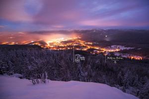 a view of a city at night in the snow at Milkowa Dolina in Szklarska Poręba