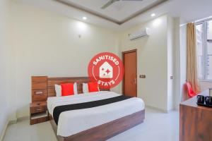 a bedroom with a bed with a red sign on it at The Grand Himalaya in Narendranagar