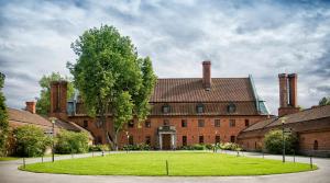 a large red brick building with two chimneys at Hotel Vanajanlinna in Hämeenlinna