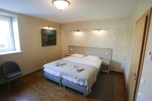 Postel nebo postele na pokoji v ubytování Hotel Jonapolis