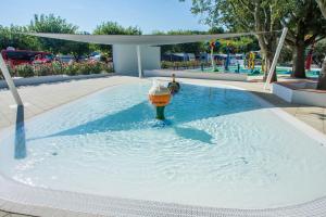 a pool of water with a fire hydrant in it at CHERRY Premium JADE Mobile homes Zelena Laguna in Poreč
