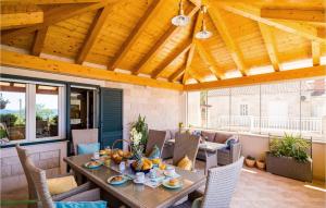 an outdoor dining room with a table and chairs at Stunning Home In Banici With Wifi in Banići