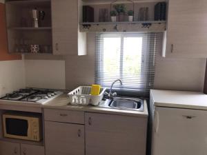 a small kitchen with a sink and a stove at Lila House in Xàtiva