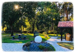 a park with a picnic table and a gazebo at Au Clair Des Landes in Castets