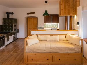 a kitchen with a couch in the middle of a room at Martinkovice 201 Broumov in Martínkovice