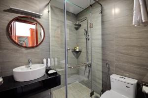 a bathroom with a toilet and a sink and a mirror at Sunflower Hotel Phú Yên in Tuy Hoa