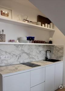 a kitchen with marble counter tops and a sink at PLAZA CABILDO 4 in Sanlúcar de Barrameda