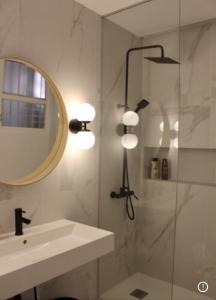 a bathroom with a shower and a sink and a mirror at PLAZA CABILDO 4 in Sanlúcar de Barrameda +4 photos