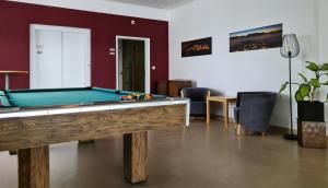 a living room with a pool table in it at Hotel Viktor in Viktorsberg