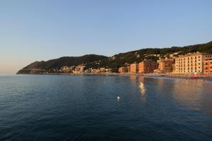 a large body of water with buildings and a city at Hotel Mambo in Laigueglia