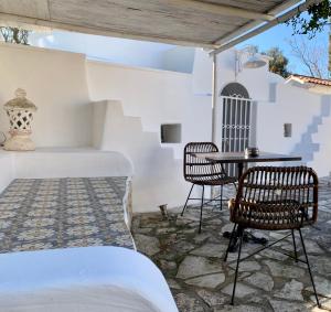 a bedroom with a table and chairs on a patio at Il Saraceno B&B in Carovigno
