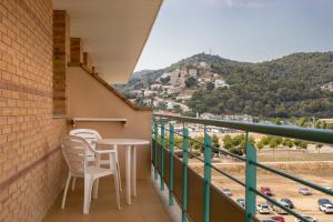 a balcony with two chairs and a table with a view at htop Royal Sun Suites 4Sup - Fun in Santa Susanna