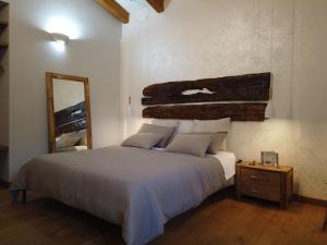 a bedroom with a large bed and a mirror at Il Mandorlo in Amantea
