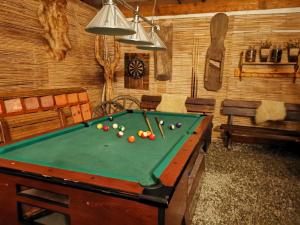 a room with a pool table with balls on it at Guesthouse Eden in Liptovský Mikuláš