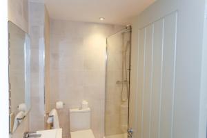 a bathroom with a shower and a toilet at Duck Bay Hotel & Restaurant in Balloch