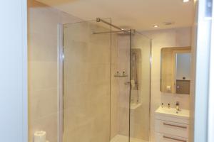 a bathroom with a shower and a sink at Duck Bay Hotel & Restaurant in Balloch