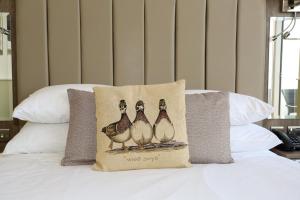 a group of three ducks pillow on a bed at Duck Bay Hotel & Restaurant in Balloch
