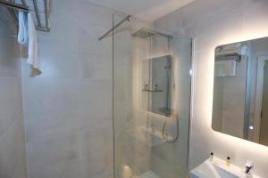 a bathroom with a glass shower with a sink at Duck Bay Hotel & Restaurant in Balloch