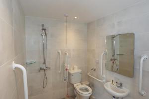 a bathroom with a shower and a toilet and a sink at Duck Bay Hotel & Restaurant in Balloch
