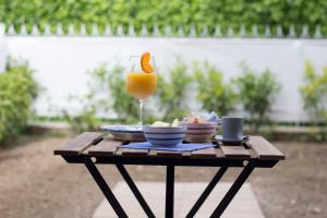 a table with a glass of orange juice and food on it at Maison Ligea in Sorrento