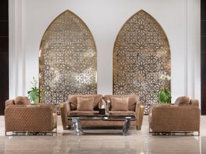 a living room with two chairs and a table at Pickalbatros Dana Beach Resort - Aqua Park in Hurghada