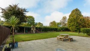 a park with a picnic table and a playground at Duck Bay Hotel & Restaurant in Balloch