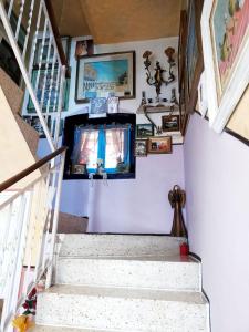 a staircase with a television in a house at Art B&B La Casa del Pittore in Revine Lago