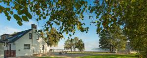 a white house with a view of the water at Duck Bay Hotel & Restaurant in Balloch