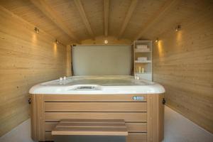 a sauna with a sink in a wooden room at Duck Bay Hotel & Restaurant in Balloch
