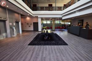 a lobby of a building with a table in the middle at Ferretti MajesticHouse in Castenedolo