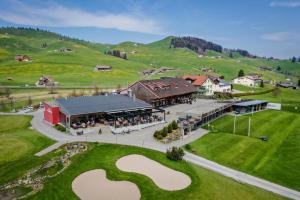 an aerial view of a building with a large heart on the lawn at Swiss Mountain Golf-Restaurant Gonten in Gonten