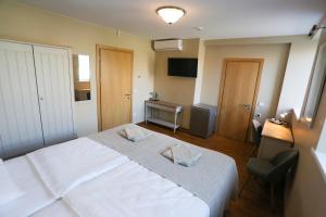 Postel nebo postele na pokoji v ubytování Hotel Jonapolis