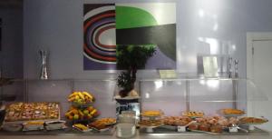 a buffet with many different types of food on a counter at Aurea Hotel in Tortoreto Lido