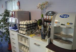 a kitchen with a coffee maker next to a counter at Aurea Hotel in Tortoreto Lido