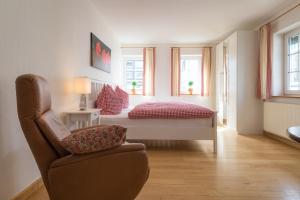 a bedroom with a bed and a chair in it at Feldmann-Schütte in Schmallenberg