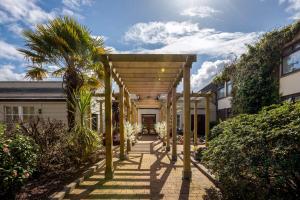 a wooden pergola in front of a house at Ardboyne Hotel in Navan