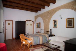 a bedroom with a bed and a couch at B&B Corte Catalana in Marigliano