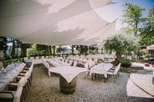 a large marquee with white tables and chairs at Villa Andor in Ankaran