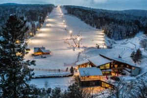 a ski resort in the snow at night at Pensjonat Laworta Ski in Ustrzyki Dolne