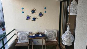 a balcony with two chairs and a table and a vase at Vilamoura Marina Extraordinary 70 m2 T1, Marina 200m , beach 300m in Vilamoura